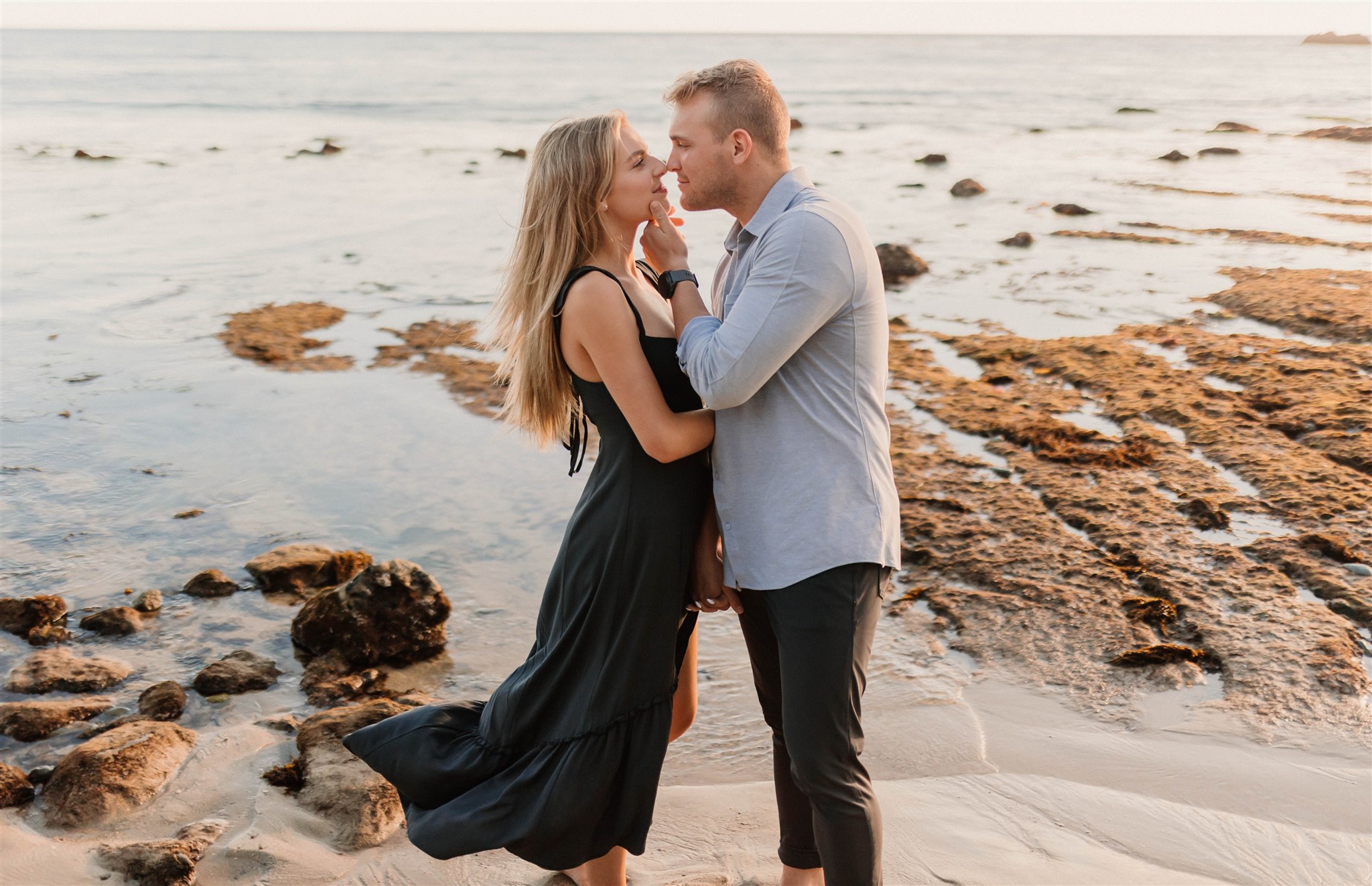 couple posing on a beach Fun and Playful Laguna Beach Couples Photos