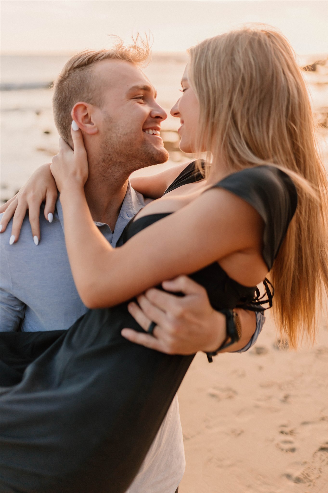 guy holding girl and twirling on a beach Fun and Playful Laguna Beach Couples Photos