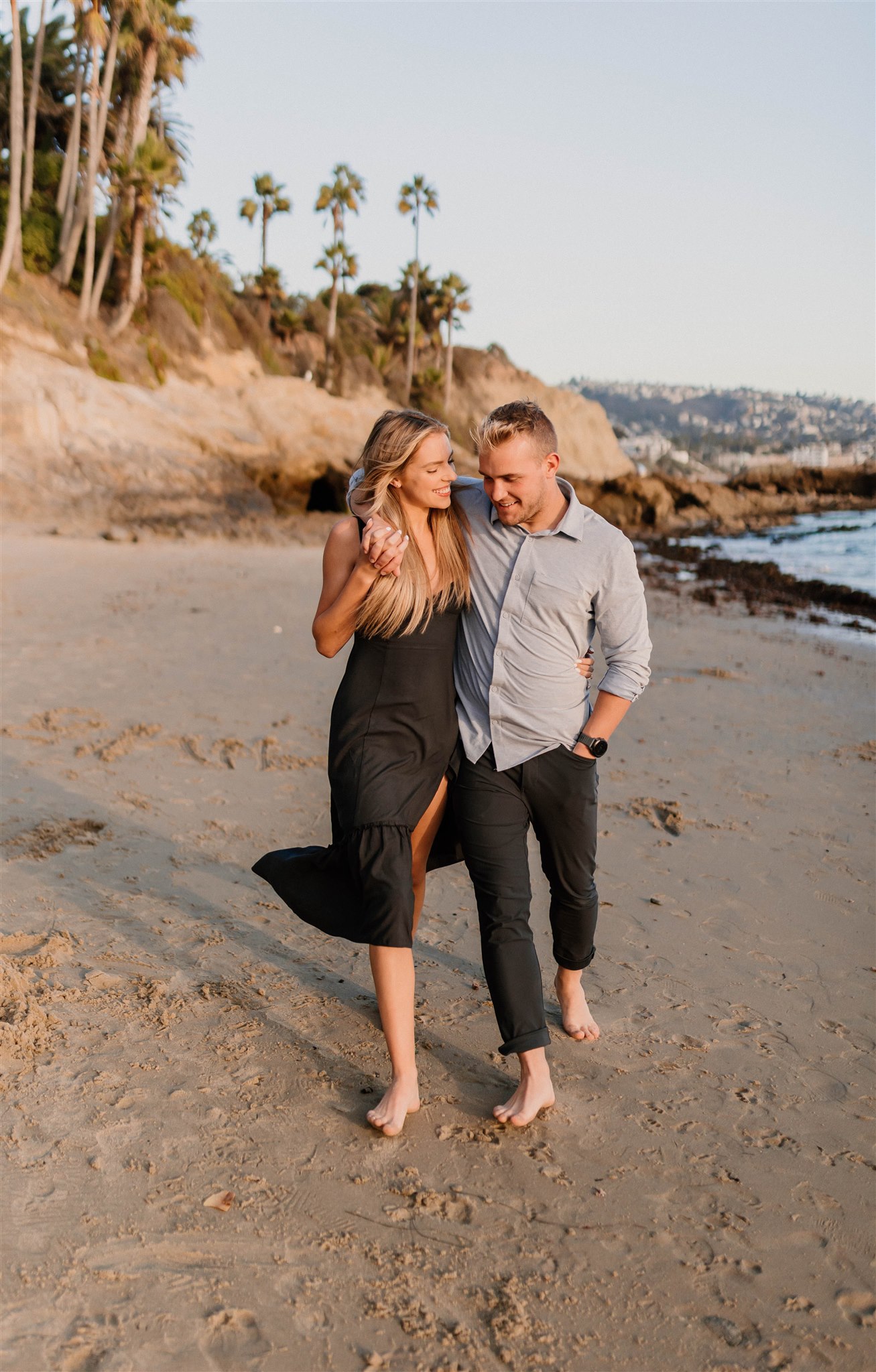couple walking on a beach Fun and Playful Laguna Beach Couples Photos