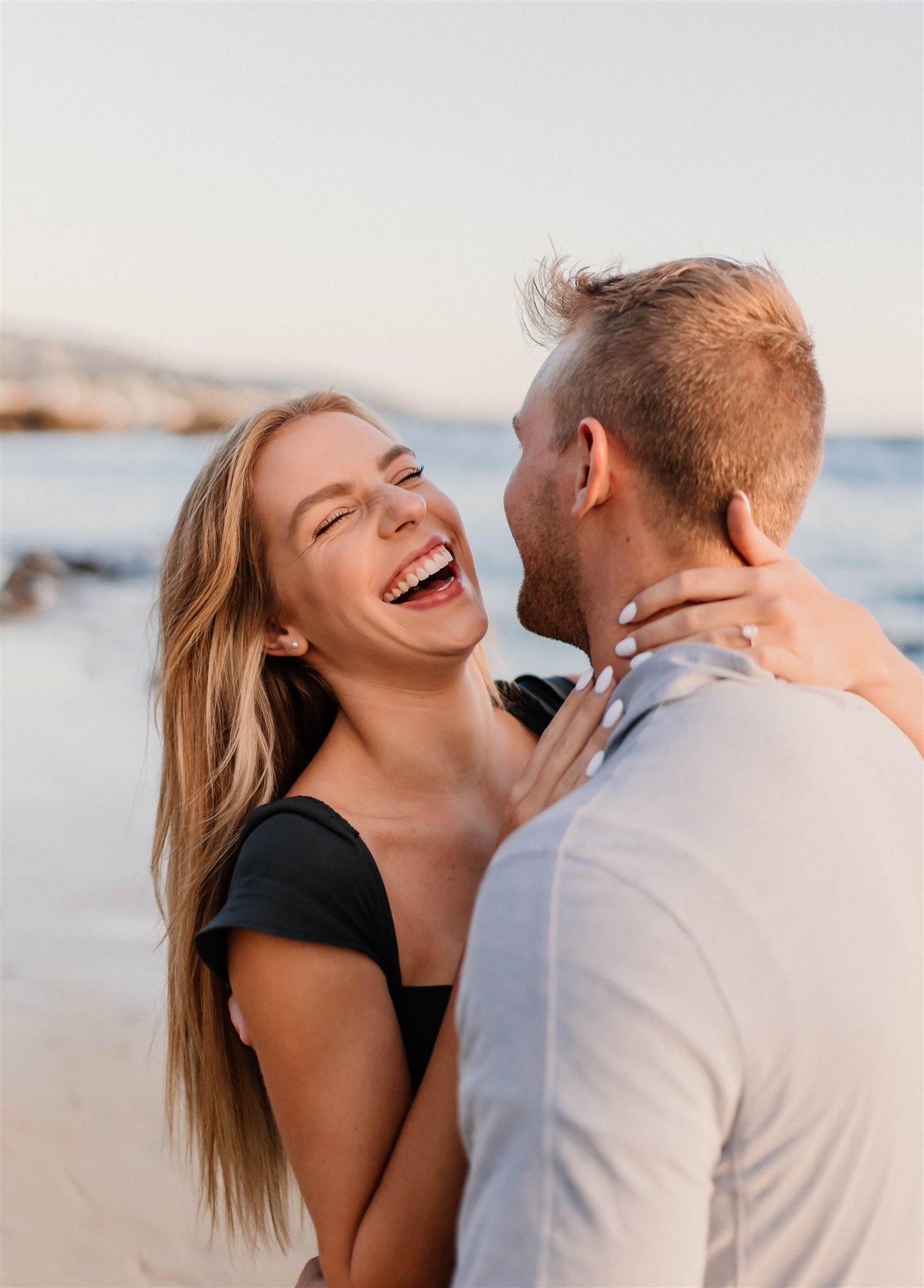 couple laughing on a beach Fun and Playful Laguna Beach Couples Photos