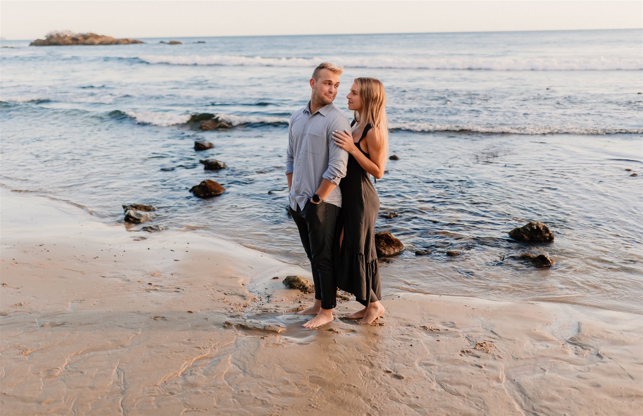couple posing in front of the ocean Fun and Playful Laguna Beach Couples Photos