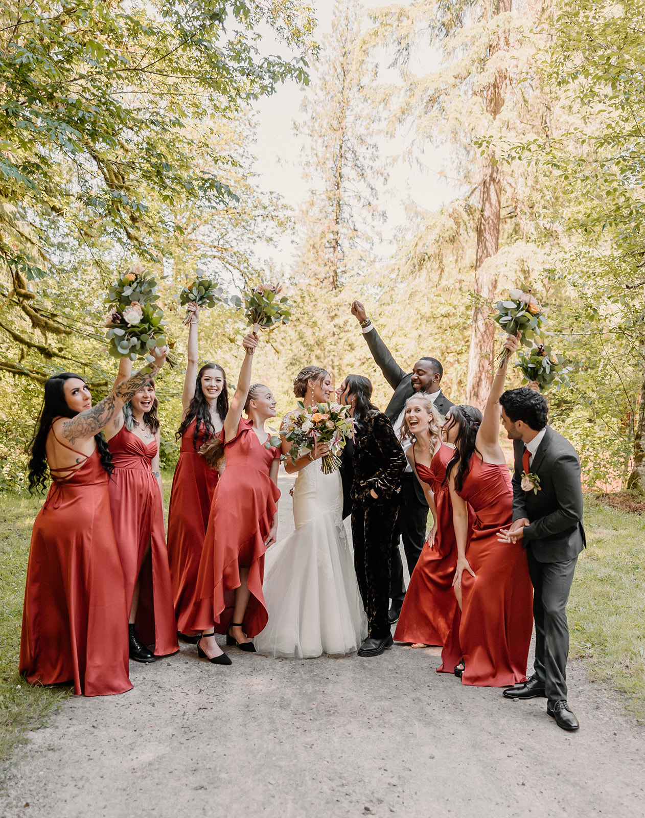bridal party posing and cheering Camp Colton - A Mystical Oregon Wedding Venue