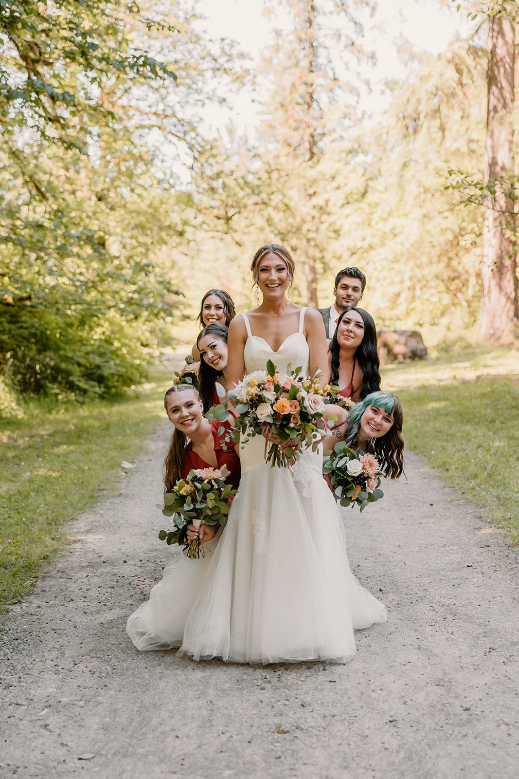 bride posing with her bridemaids Camp Colton - A Mystical Oregon Wedding Venue