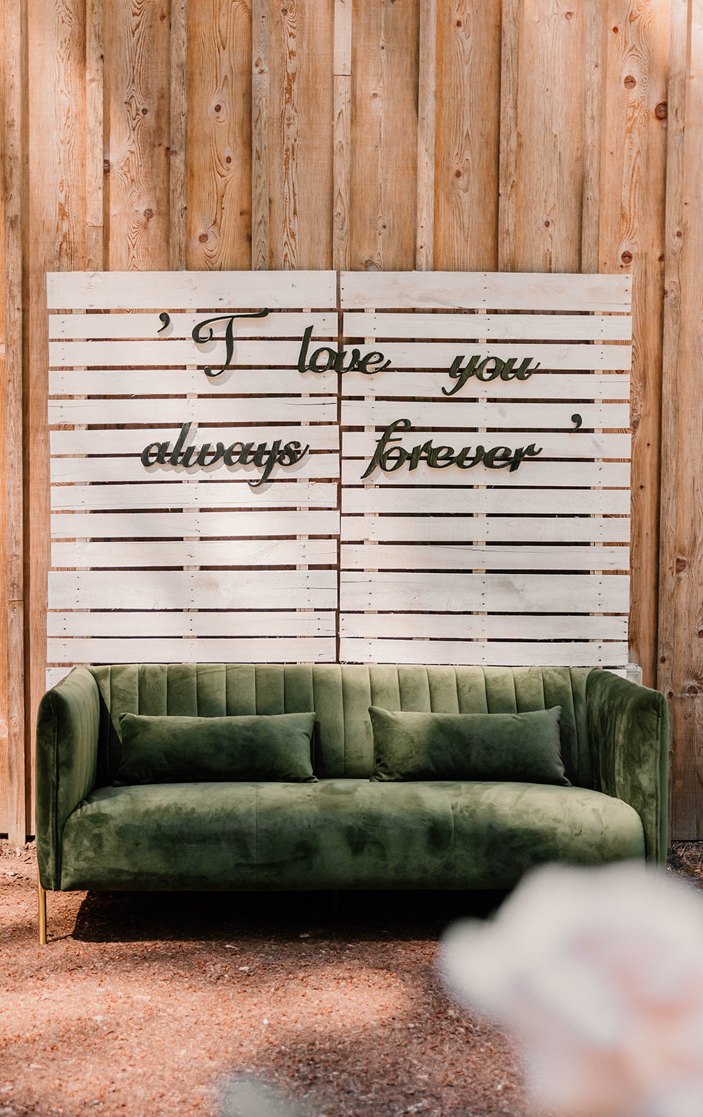 wedding decor details with a sign and a green couch