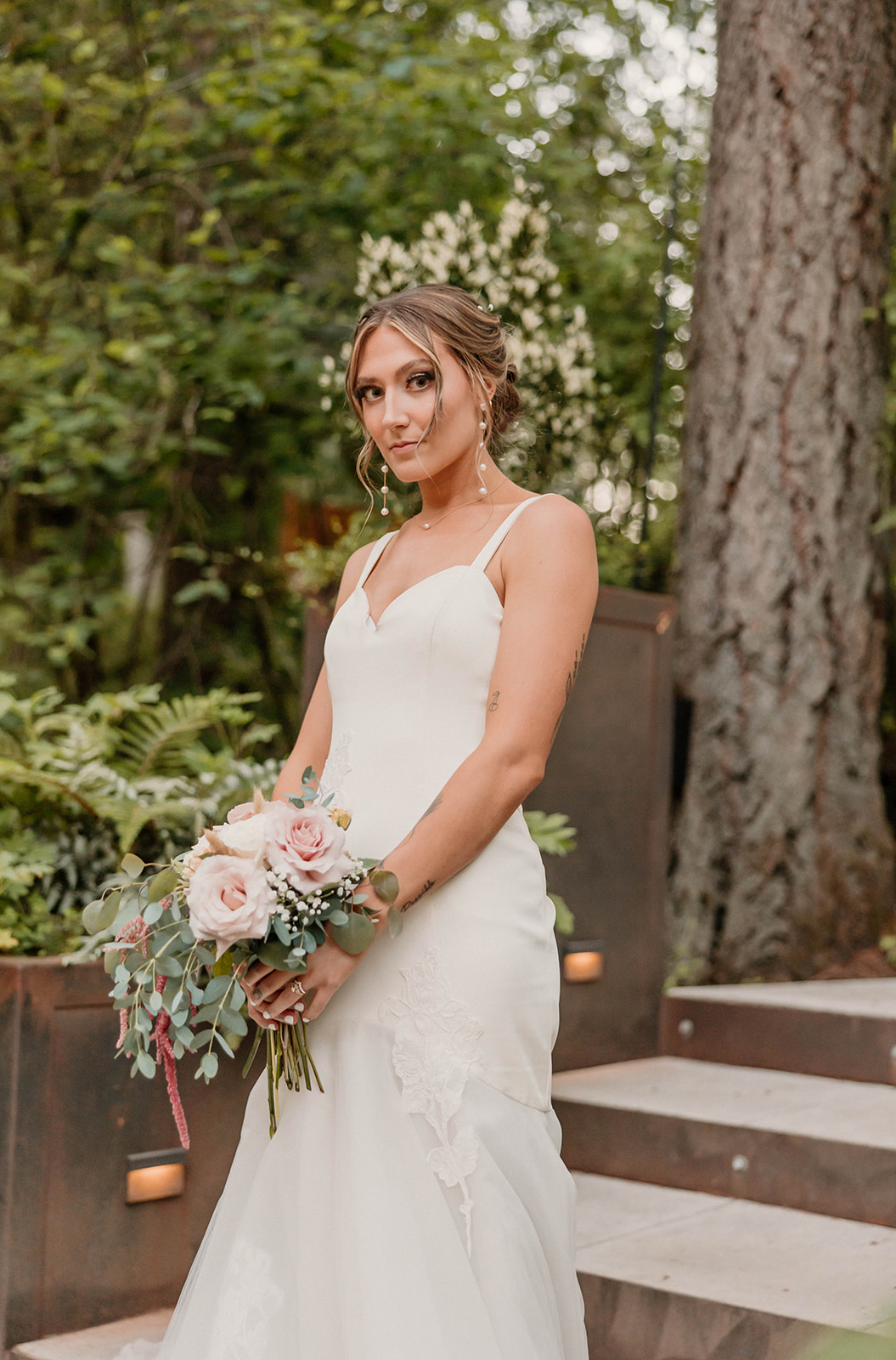 bride posing on her wedding day with flowers Camp Colton - A Mystical Oregon Wedding Venue