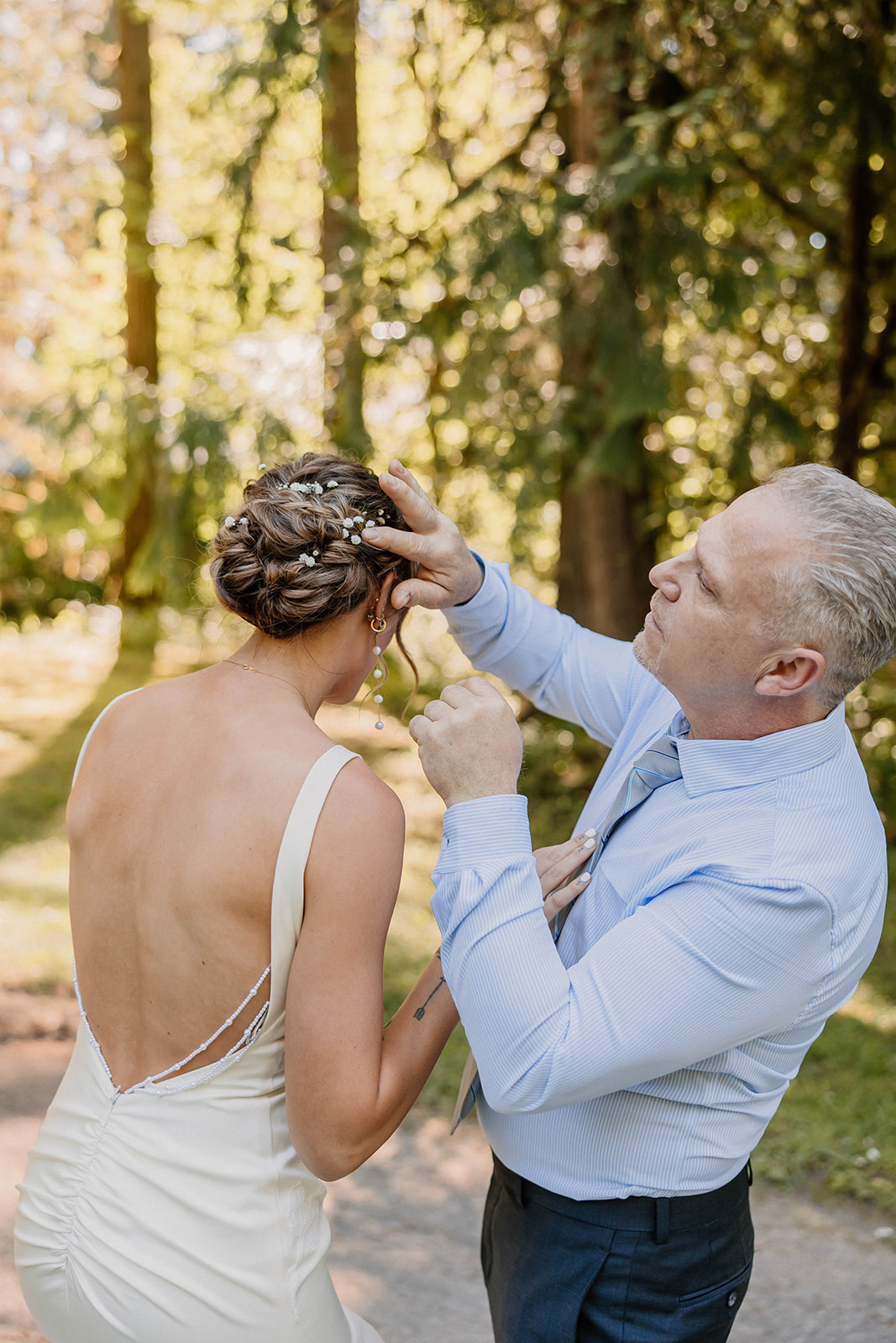 brides father fixing her hair on her wedding day Camp Colton - A Mystical Oregon Wedding Venue