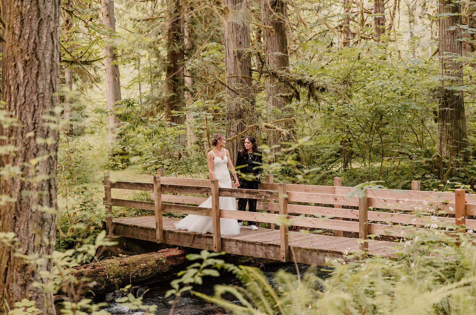married couple walking on a bridge