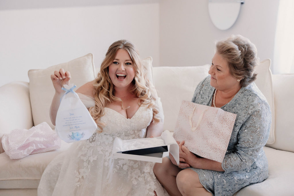 Bride opening custom wedding gift from her mother 