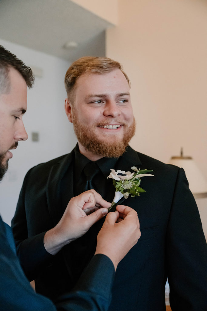groom getting his corsage on