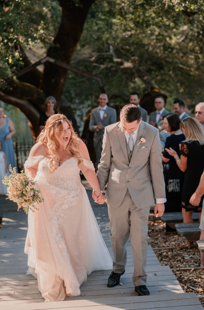 Bride and groom walking down the aisle during bay area in california wedding at mountain house estate