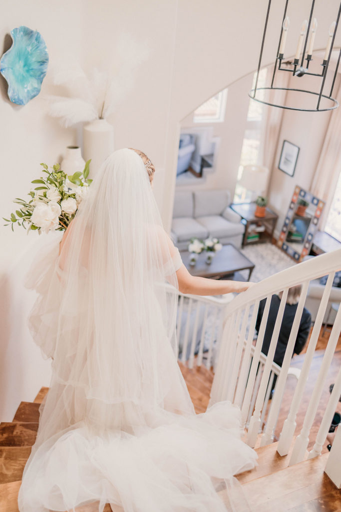 Bride walking down stairs before wedding ceremony