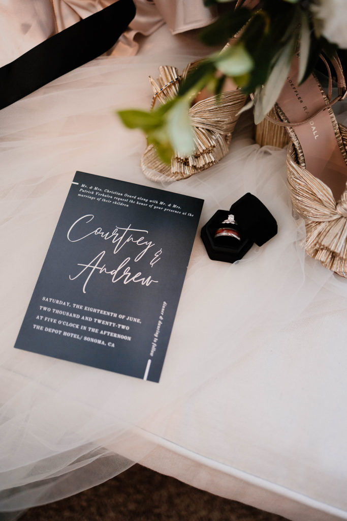 Sanoma CA wedding detail photograph with wedding invitation and wedding rings