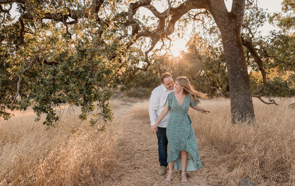 Couple posing for engagement photos in Crane Creek Regional Park in California Sanoma County