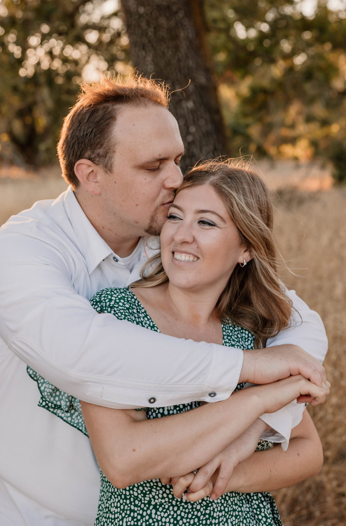 Couple posing for engagement photos in Crane Creek Regional Park in California Sanoma County