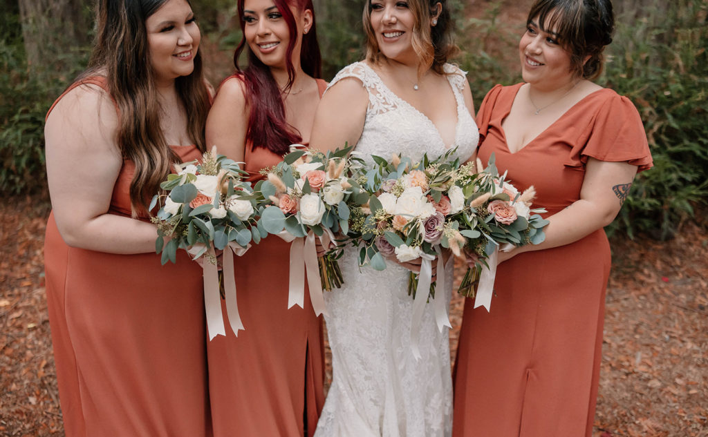 Bride and bridesmaids posing with bouquets