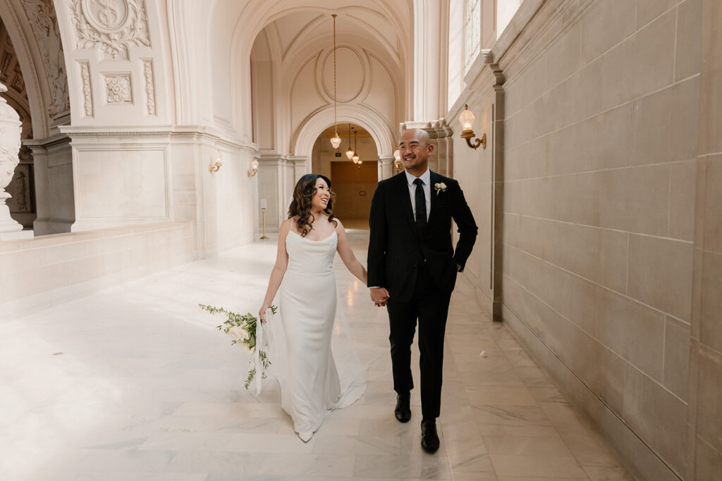 Bride and groom posing ofr portraits for City Hall wedding San Francisco elopement