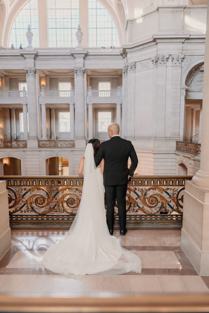 Bride and groom posing ofr portraits for City Hall wedding San Francisco elopement
