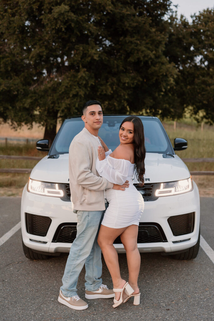Couple posing with Range Rover 