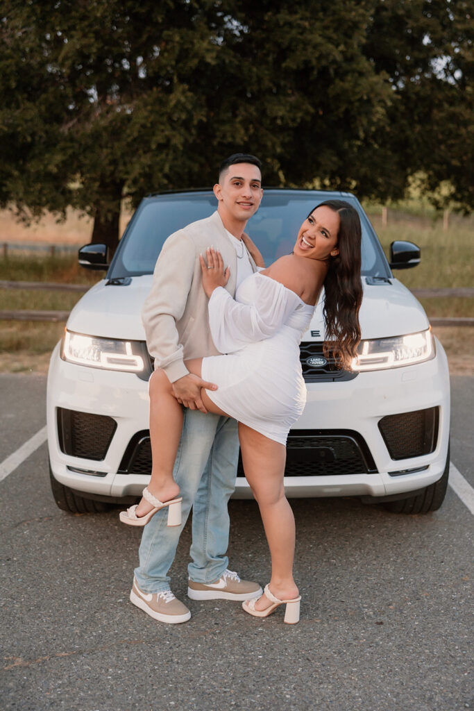 Couple posing with Range Rover 