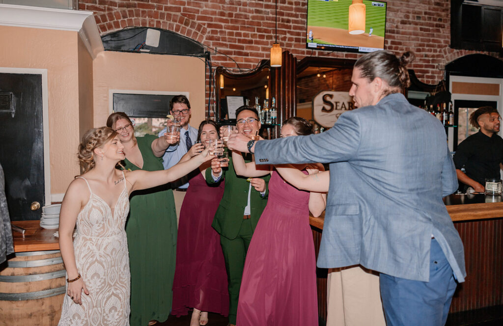 Bride toasting with wedding party during reception