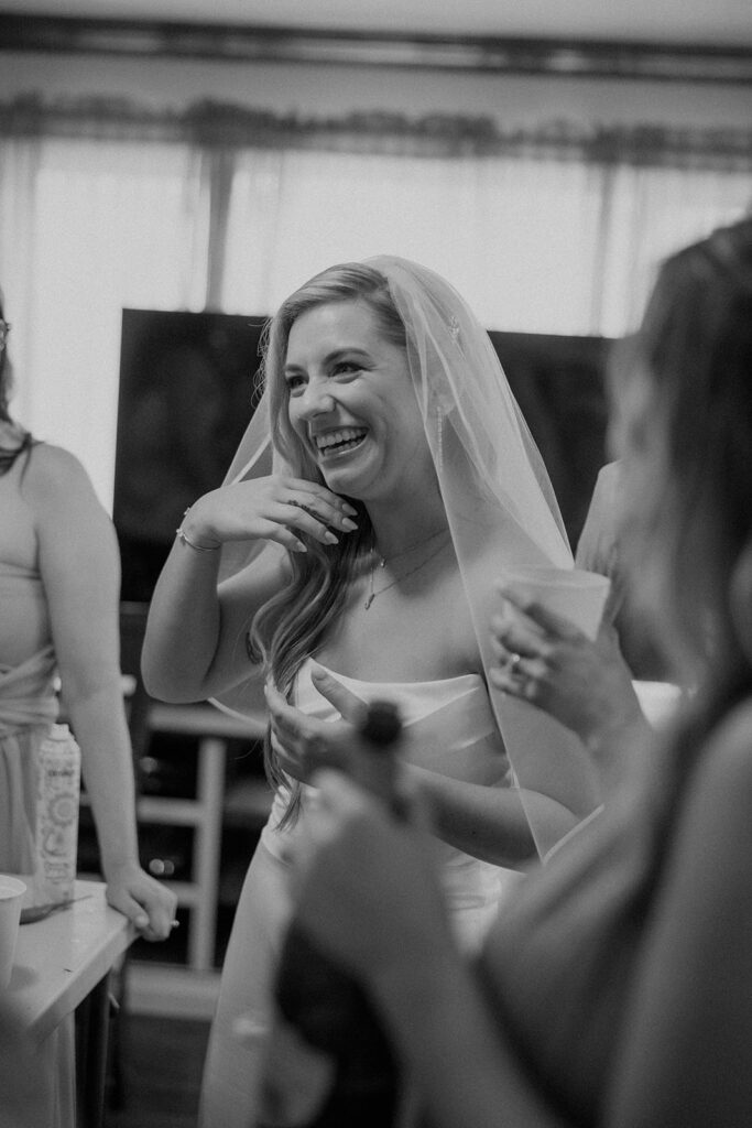 Bride taking a drink with bridesmaids
