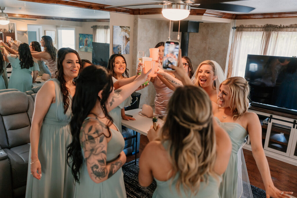 Bride taking a drink with bridesmaids