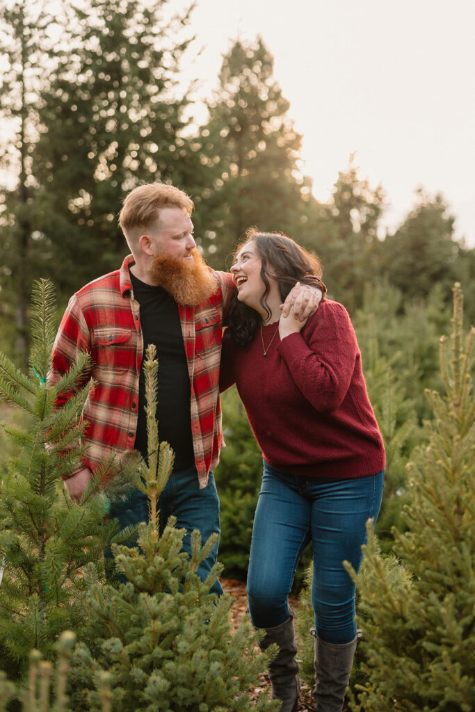 Couple posing for photos at a tree farm
