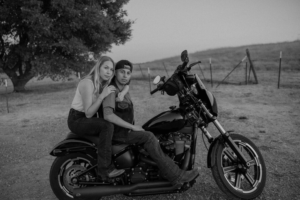 couple posing with their motorcycle
