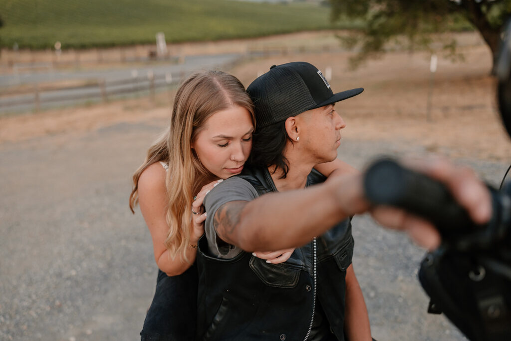 couple posing with their motorcycle
