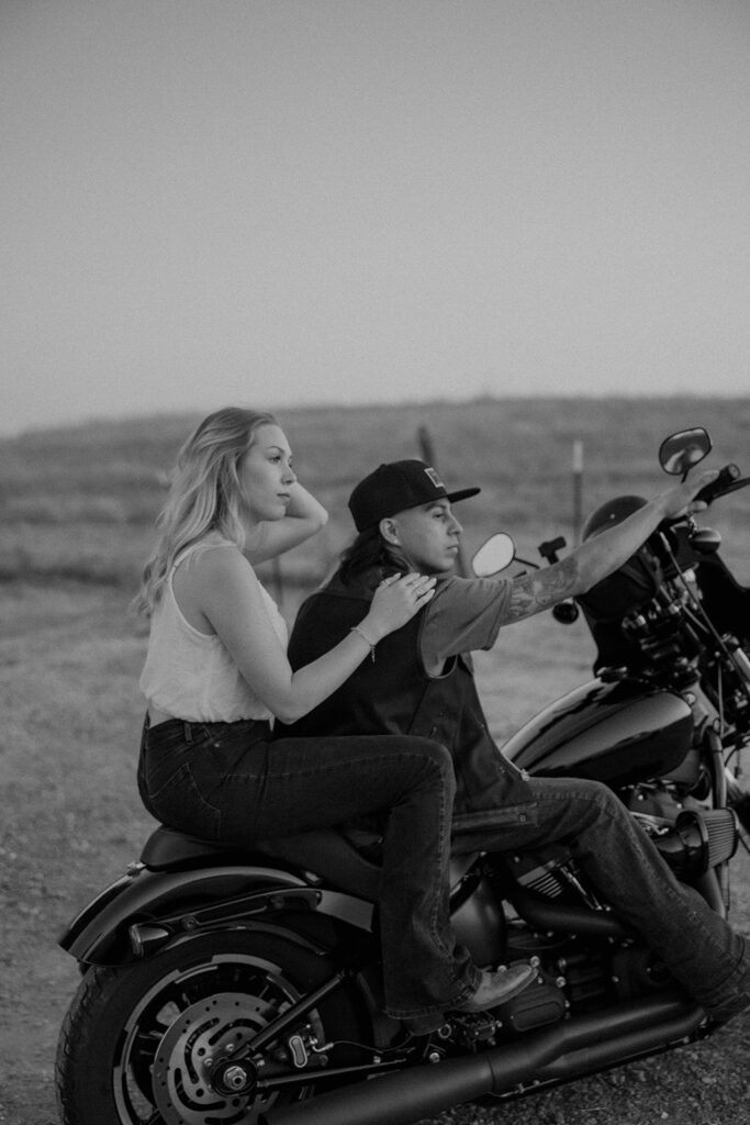 couple posing with their motorcycle
