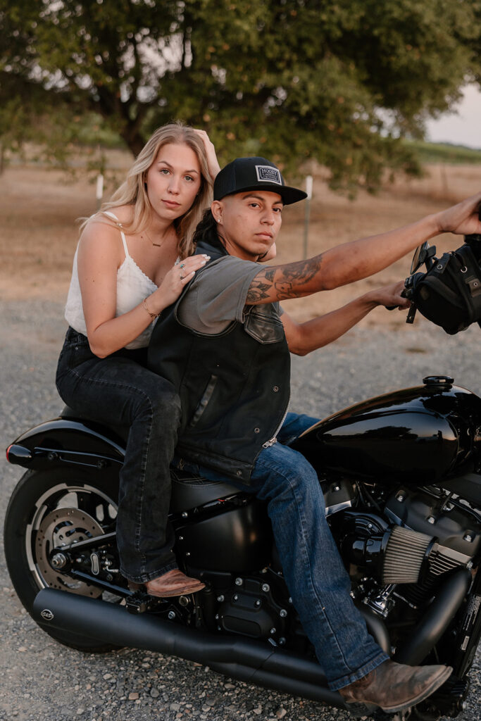 couple posing with their motorcycle
