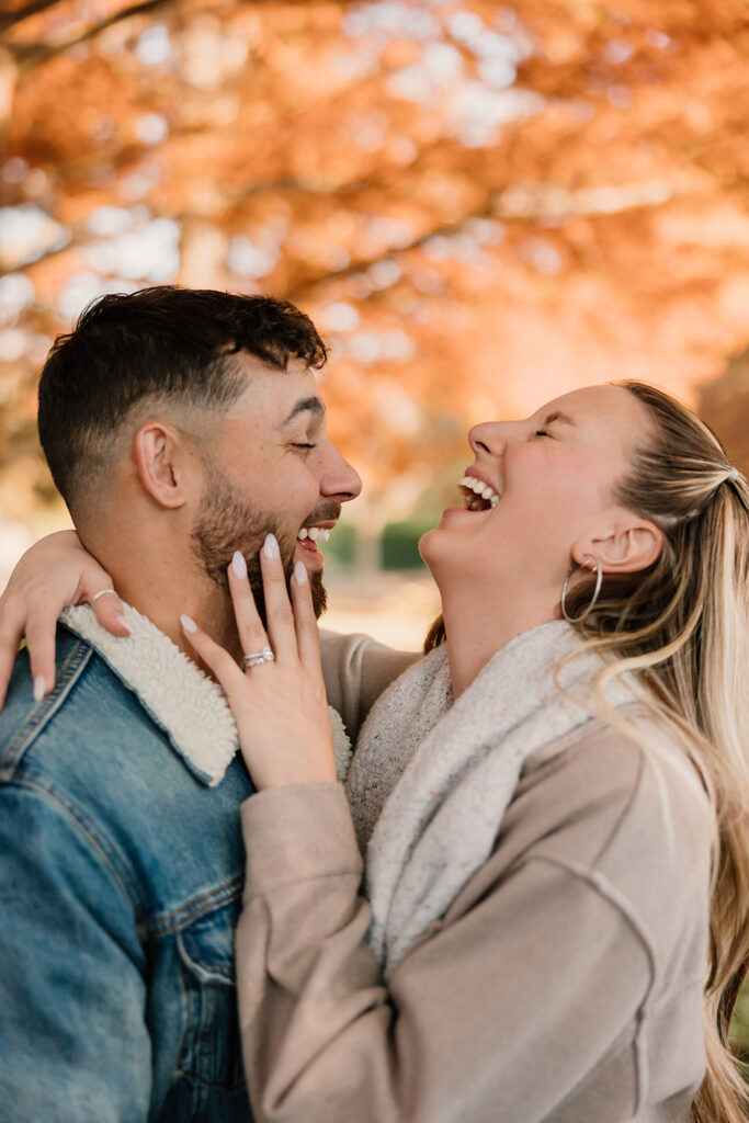 couple posing outdoors for an engagement
