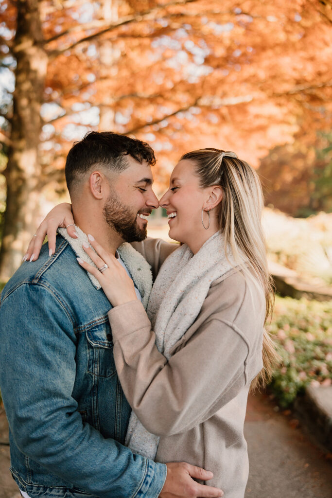 Couple taking engagement photos outside
