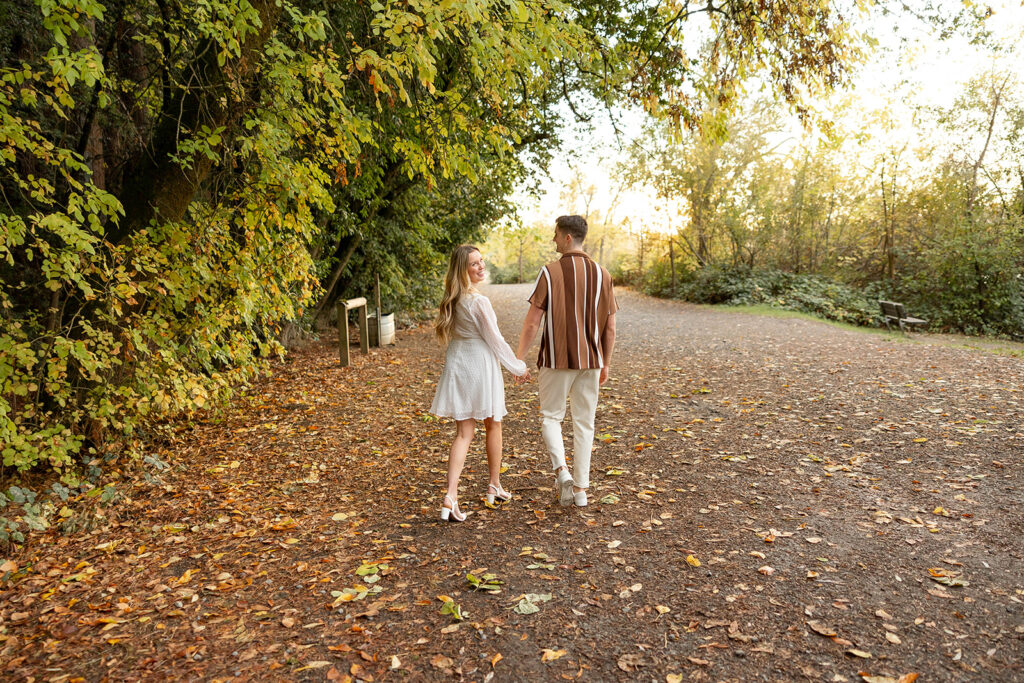 couple outside posing for engagement photos
