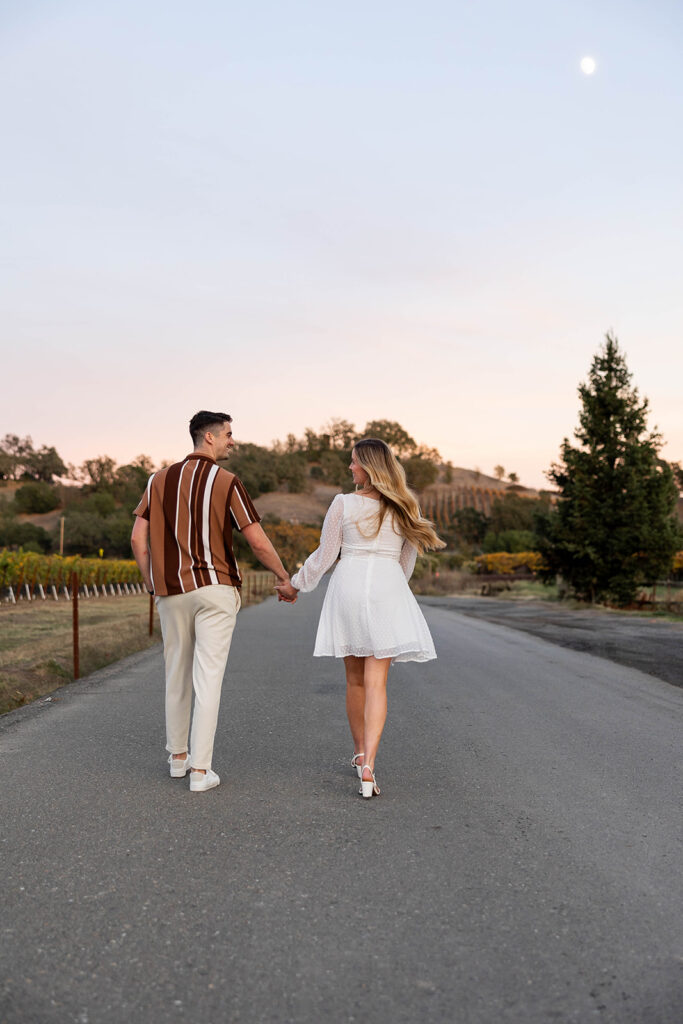 couple outside posing for engagement photos
