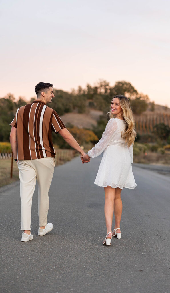 couple outside posing for engagement photos
