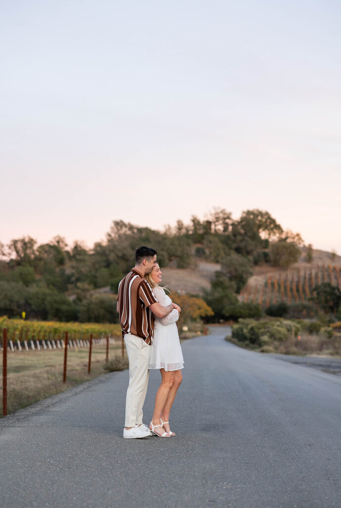 couple outside posing for engagement photos
