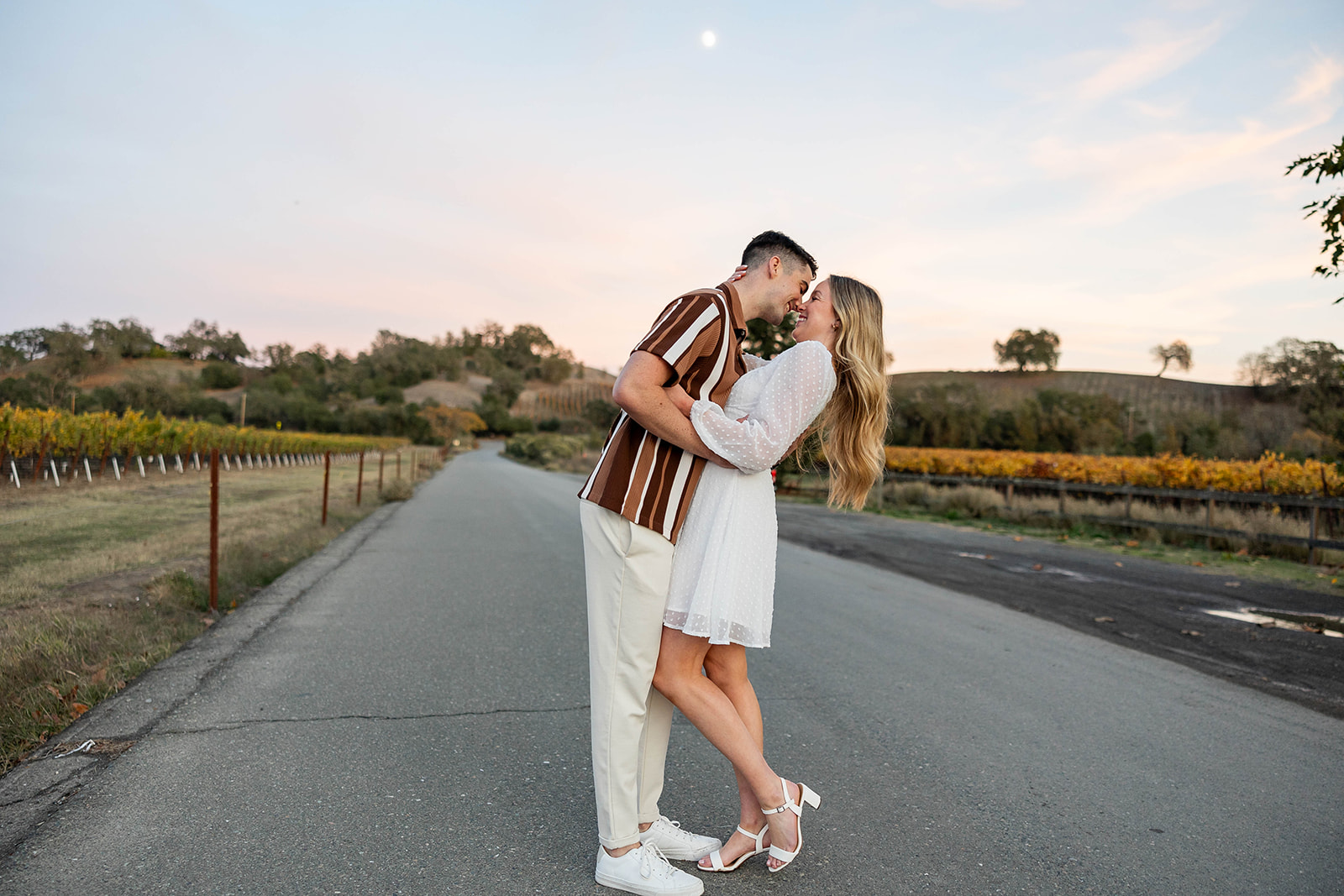 couple outside posing for engagement photos