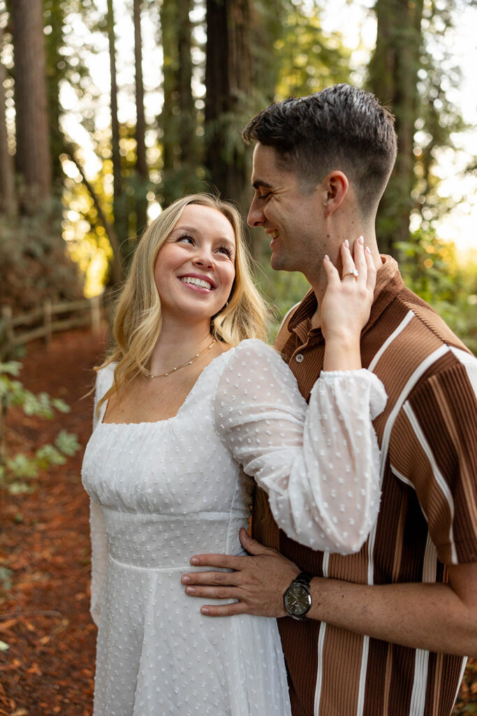 couple outside posing for engagement photos
