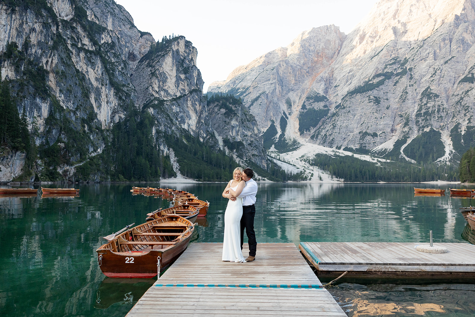 A couple standing together during their destination elopement photoshoot at Lago di Braies in the Dolomites, Italy.