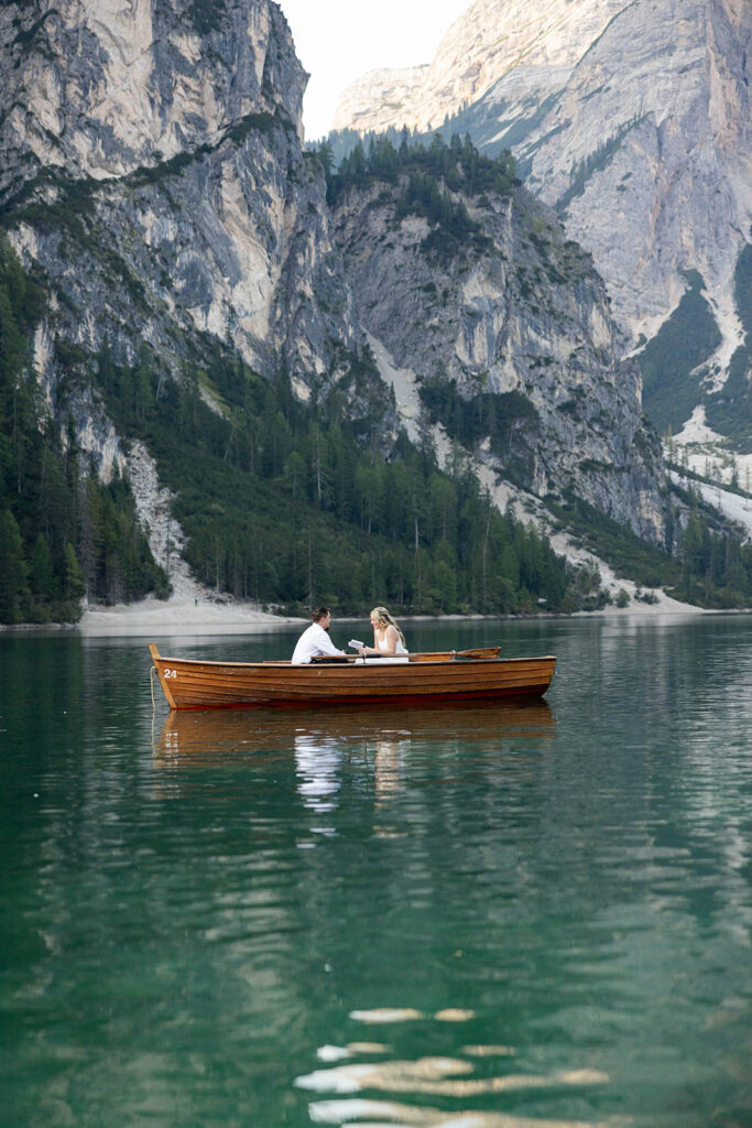 A couple standing together during their destination elopement photoshoot at Lago di Braies in the Dolomites, Italy.
