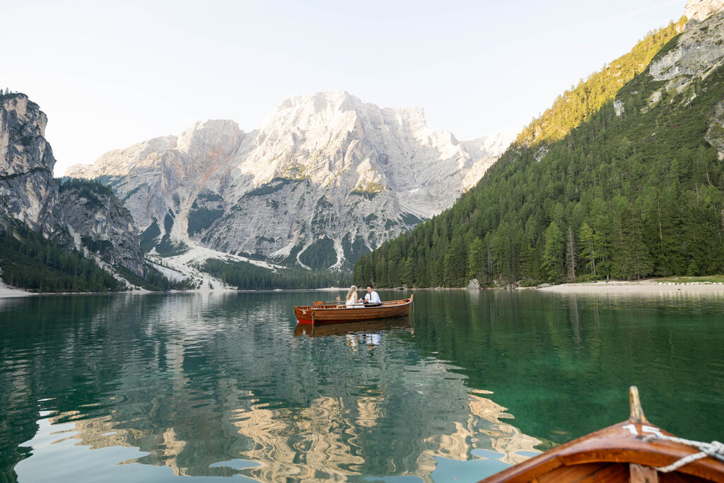 A couple standing together during their destination elopement photoshoot at Lago di Braies in the Dolomites, Italy.
