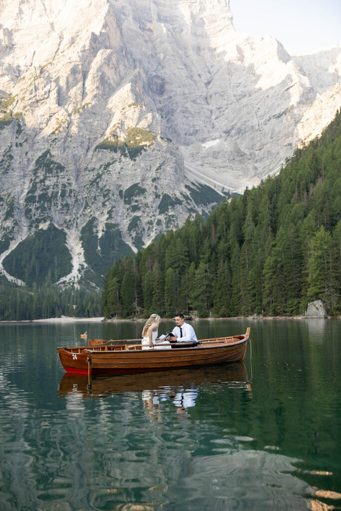 A couple standing together during their destination elopement photoshoot at Lago di Braies in the Dolomites, Italy.
