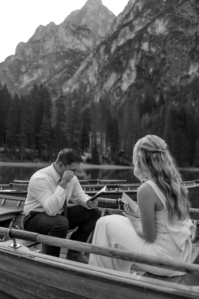 A couple standing together during their destination elopement photoshoot at Lago di Braies in the Dolomites, Italy.