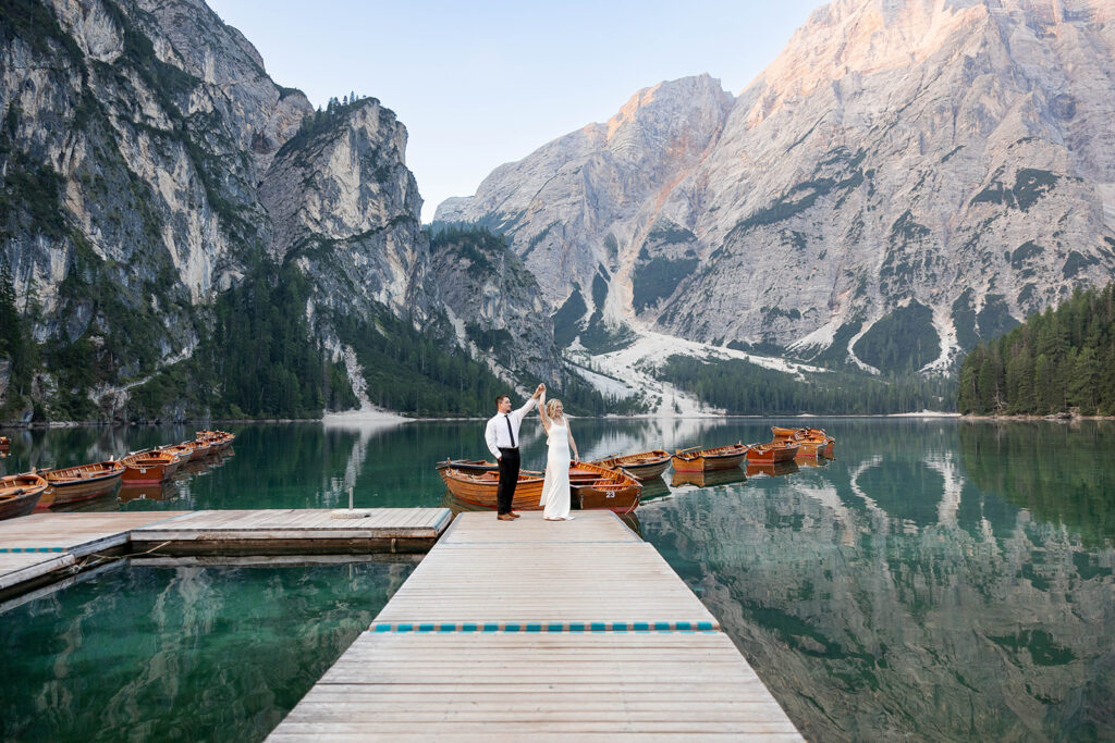 A couple standing together during their destination elopement photoshoot at Lago di Braies in the Dolomites, Italy.