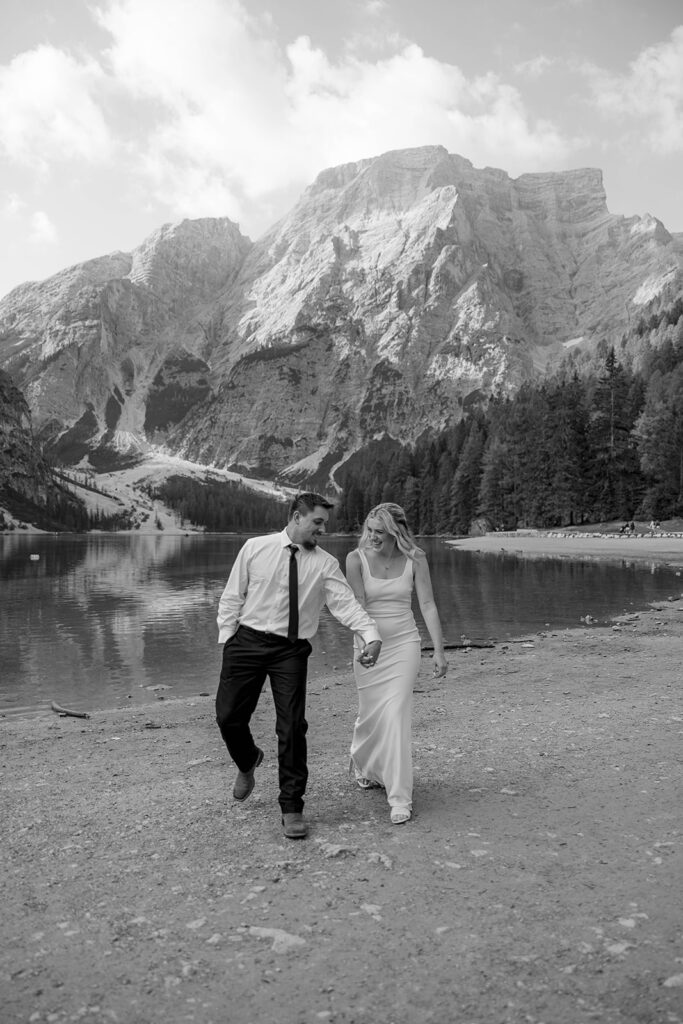 A couple standing together during their destination elopement photoshoot at Lago di Braies in the Dolomites, Italy.
